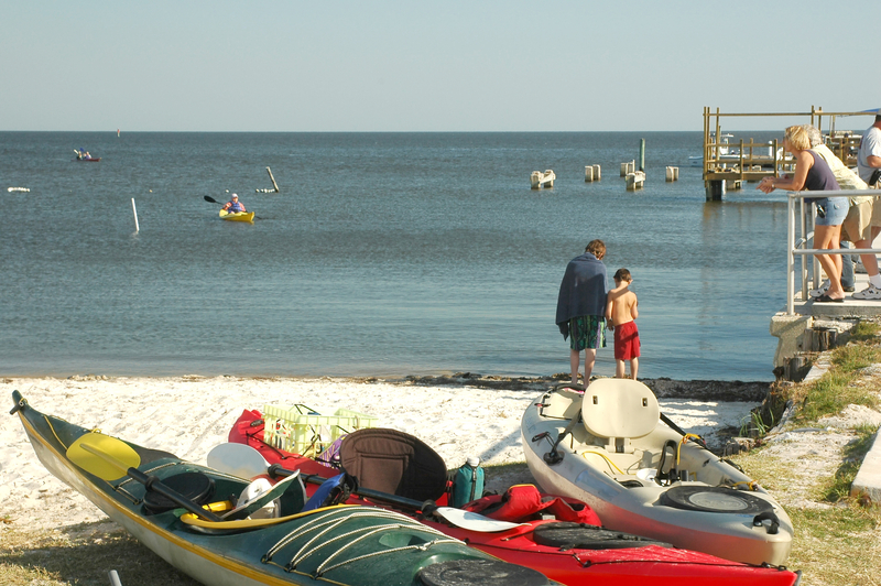 Kayaks await paddlers on the beach at Cedar Key, Florida on the Gulf of Mexico.